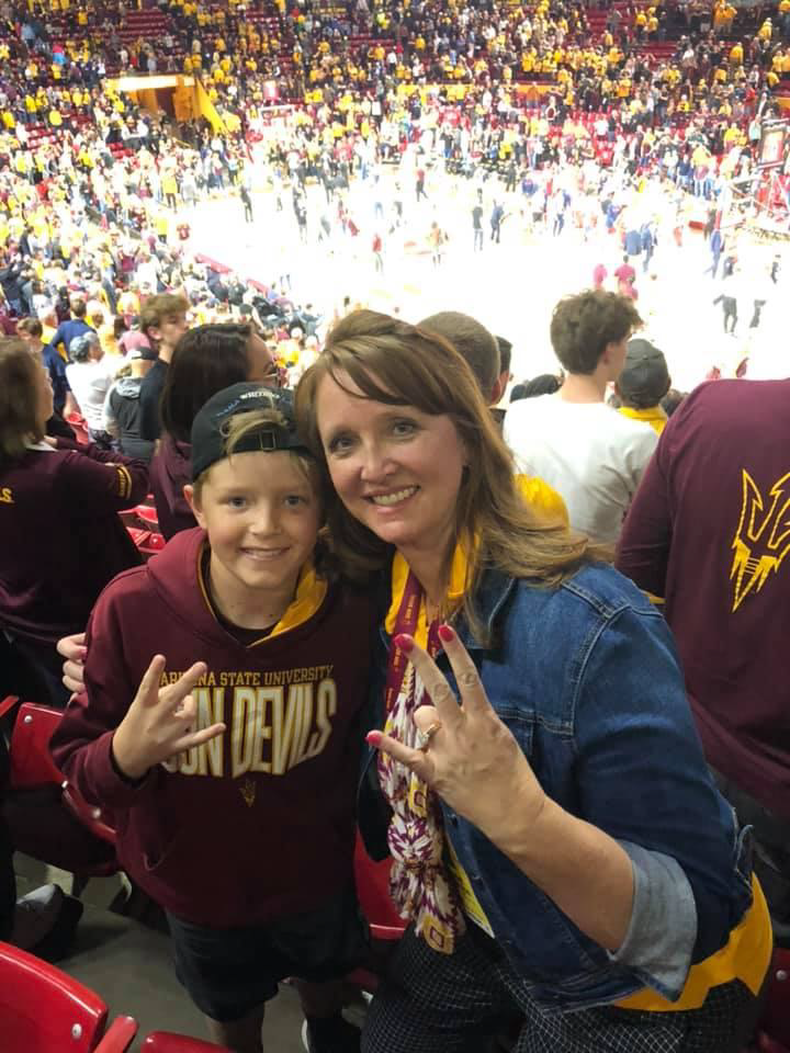 Bridget and son at basketball game.